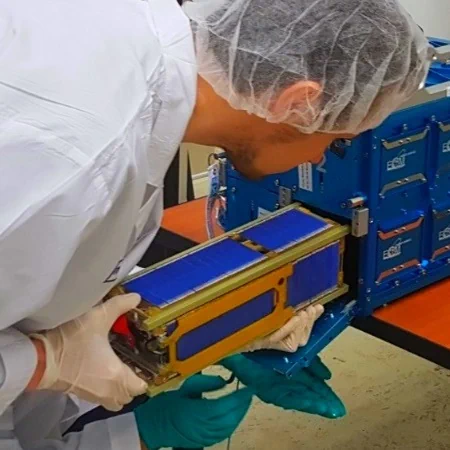 installing a satellite in a deployer container for launching into space